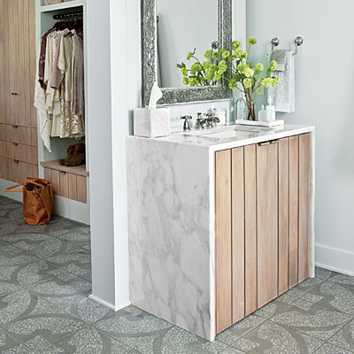 Unique bathroom vanity wood surrounded by Artisan Stone Collection Calacatta Gold Marble.